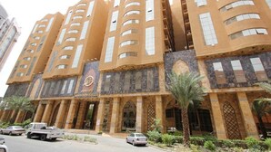 A multi-story building with a distinctive architectural style, featuring arched windows and a central entrance. - Abraj Al Tayseer Tuwa Hotel (Makkah)