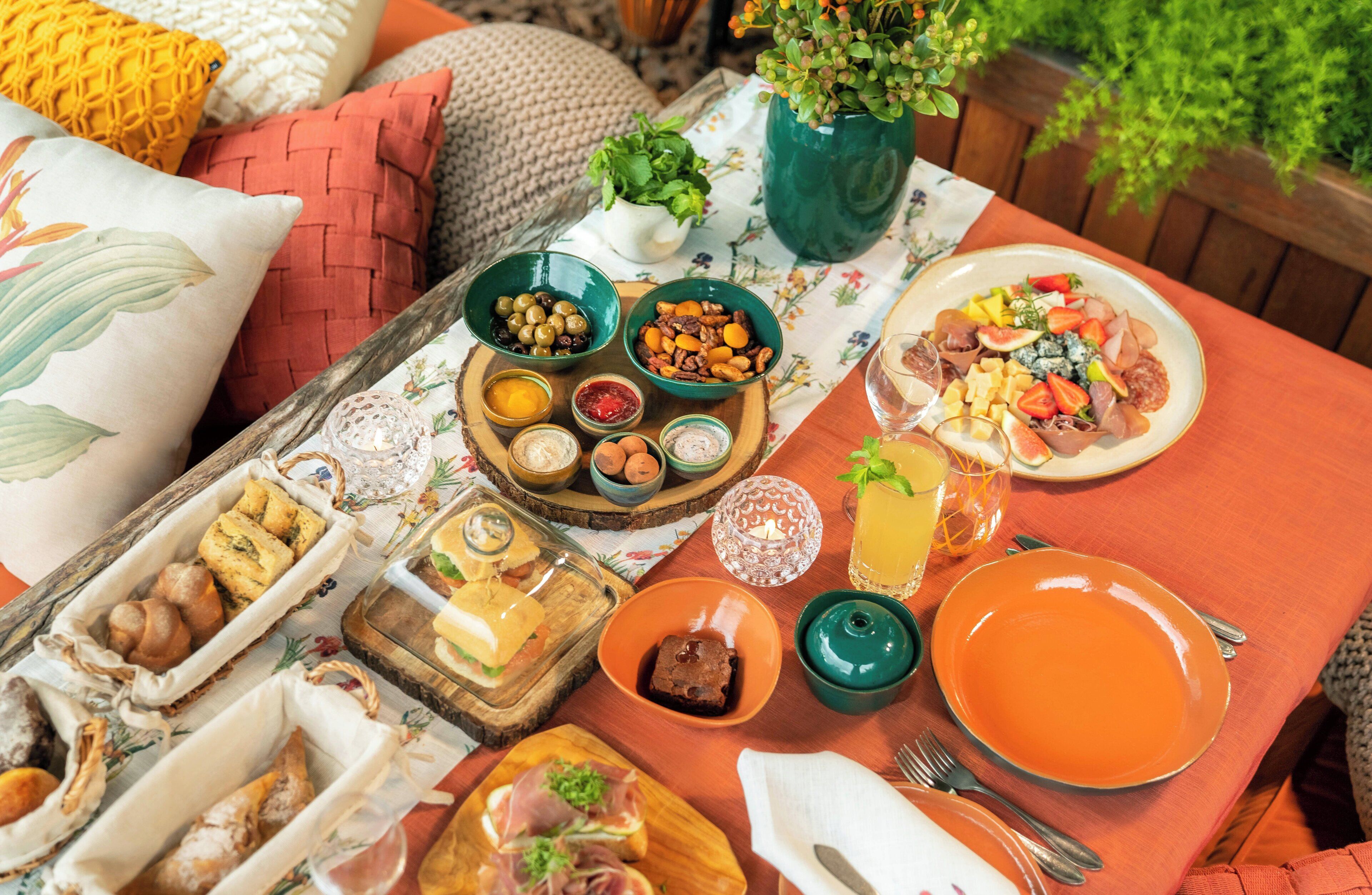 A table set with various food items, including fruits, nuts, and pastries, suggesting a breakfast or brunch setting.