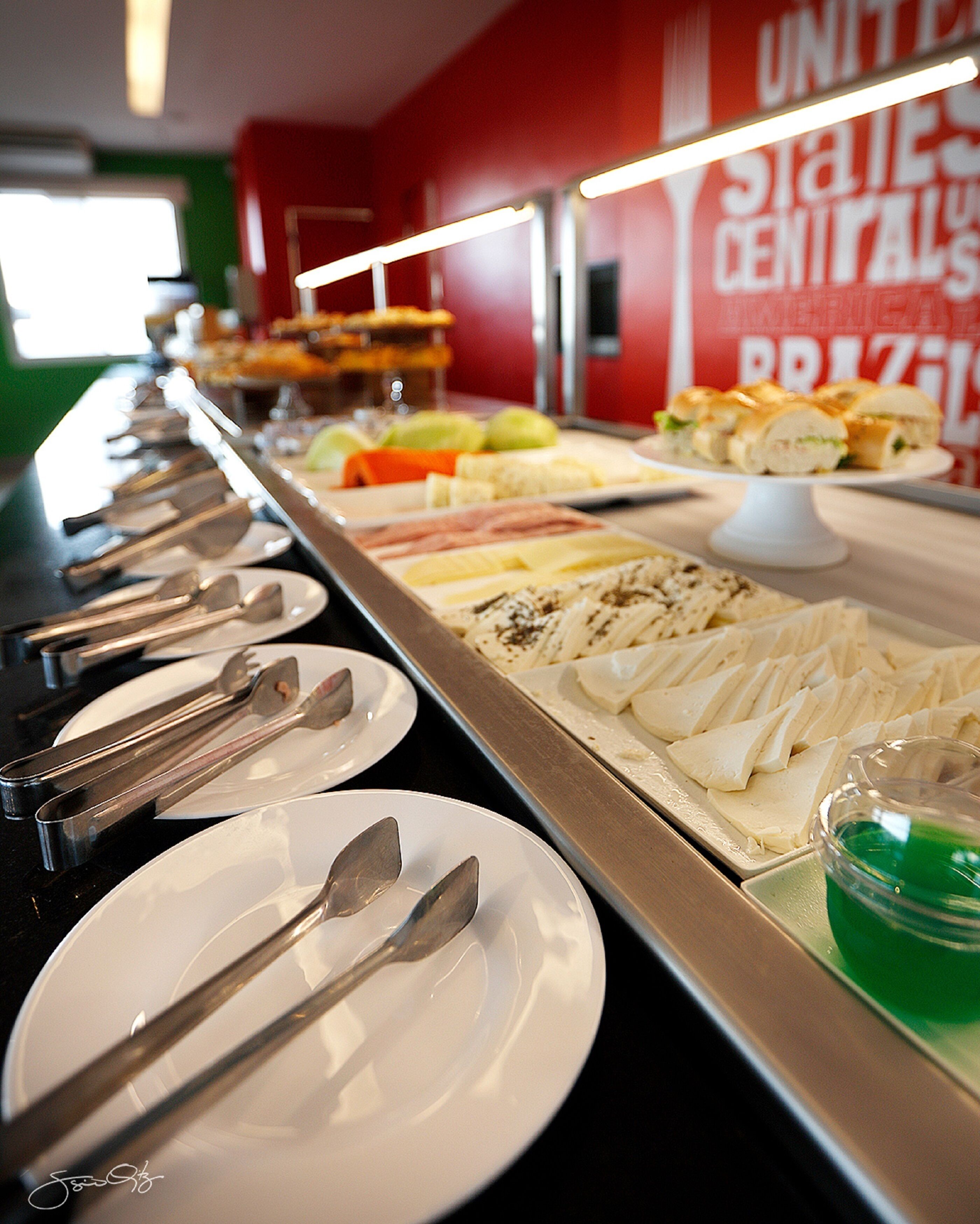 A buffet with various food items and utensils laid out on a counter.