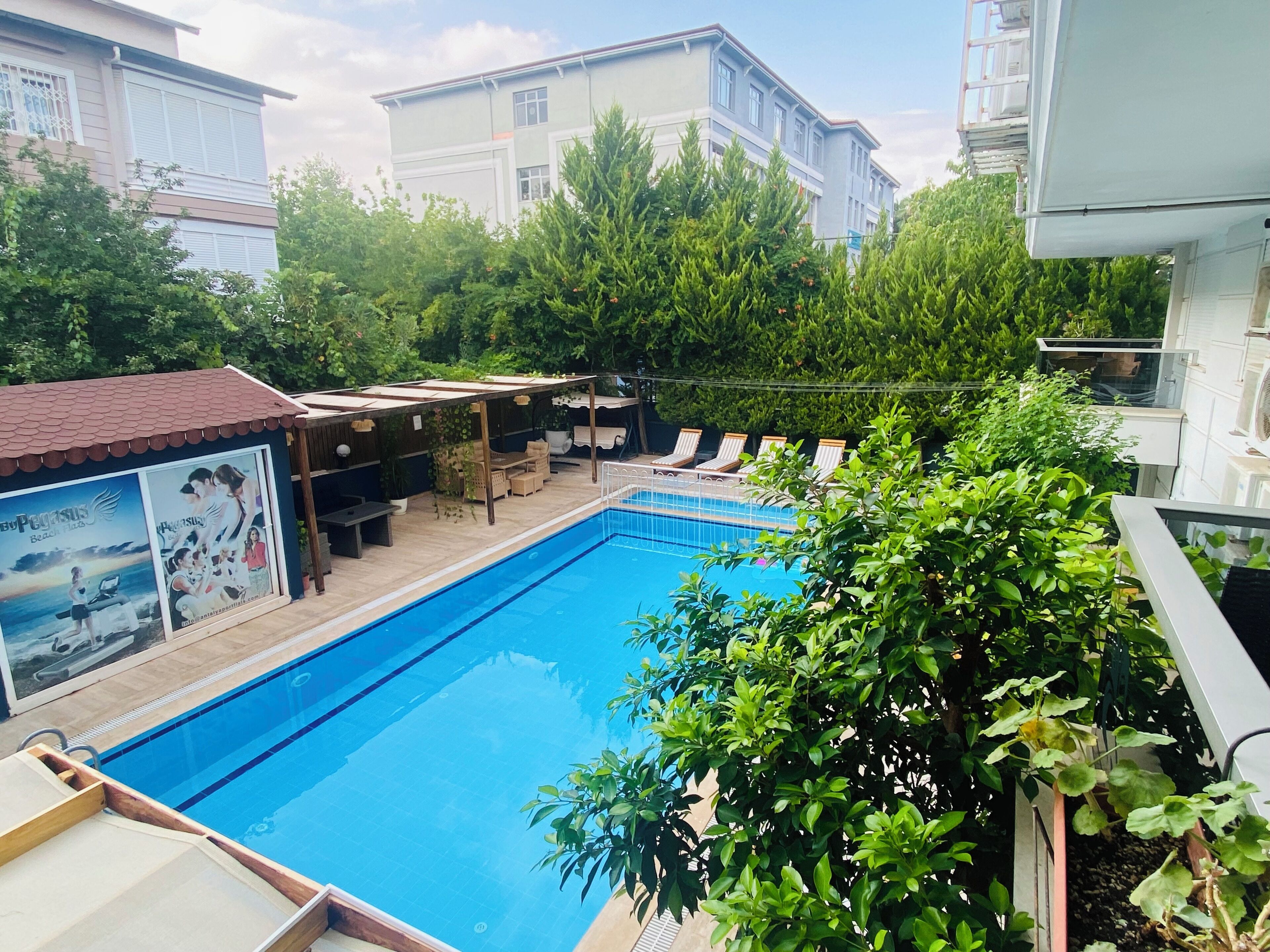 Seasonal outdoor pool, open 9:00 AM to 7:00 PM, pool umbrellas