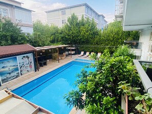 Seasonal outdoor pool, open 9:00 AM to 7:00 PM, pool umbrellas