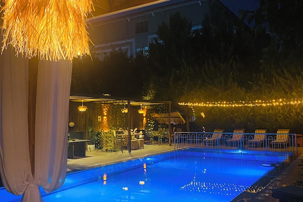 Seasonal outdoor pool, open 9:00 AM to 7:00 PM, pool umbrellas