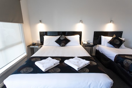 Deluxe Room, Multiple Beds, Non Smoking, Kitchenette (Walk-in Shower) | Desk, laptop workspace, blackout drapes, soundproofing