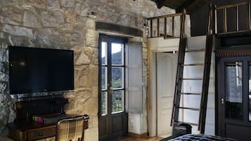 Enjoy a cozy retreat with a flat-screen TV, comfortable chair, and access to an outdoor area.