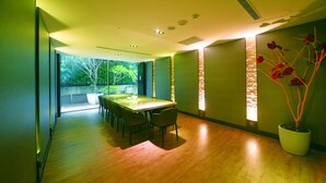 A modern dining area with a wooden table and chairs, large windows, and a potted plant. - Taipei 101 SPARKLE Hotel (Taipei)