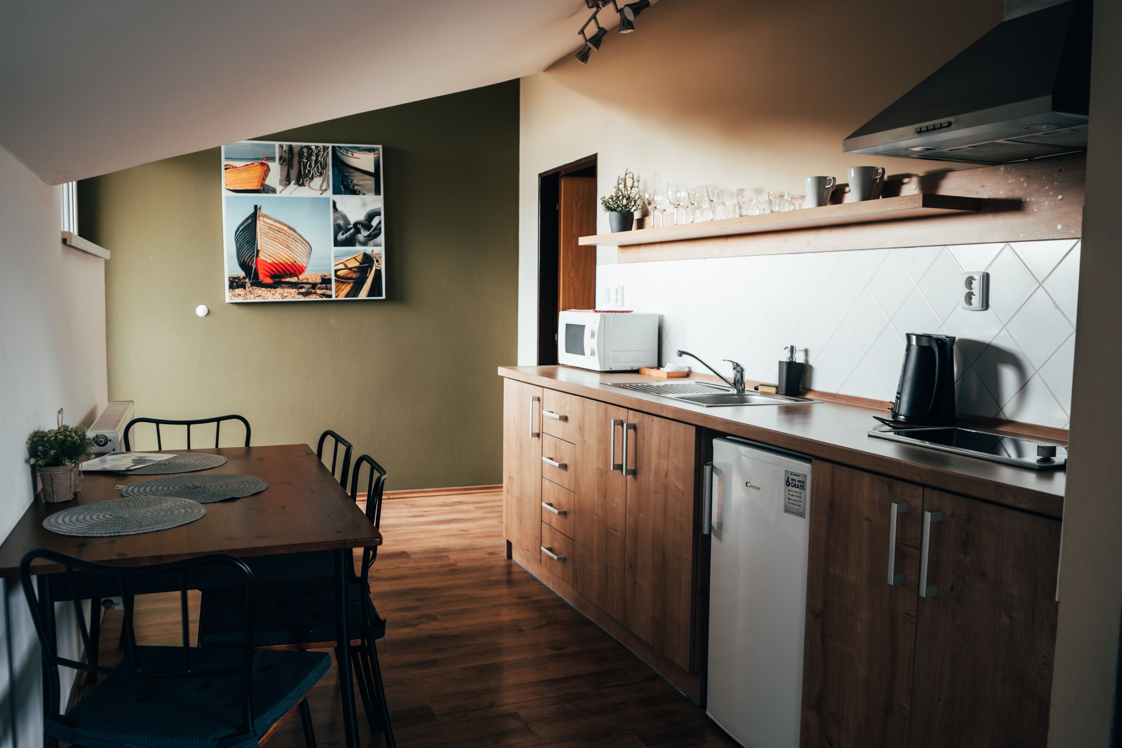 A modern kitchen with wooden cabinets, a built-in microwave, and a coffee maker.