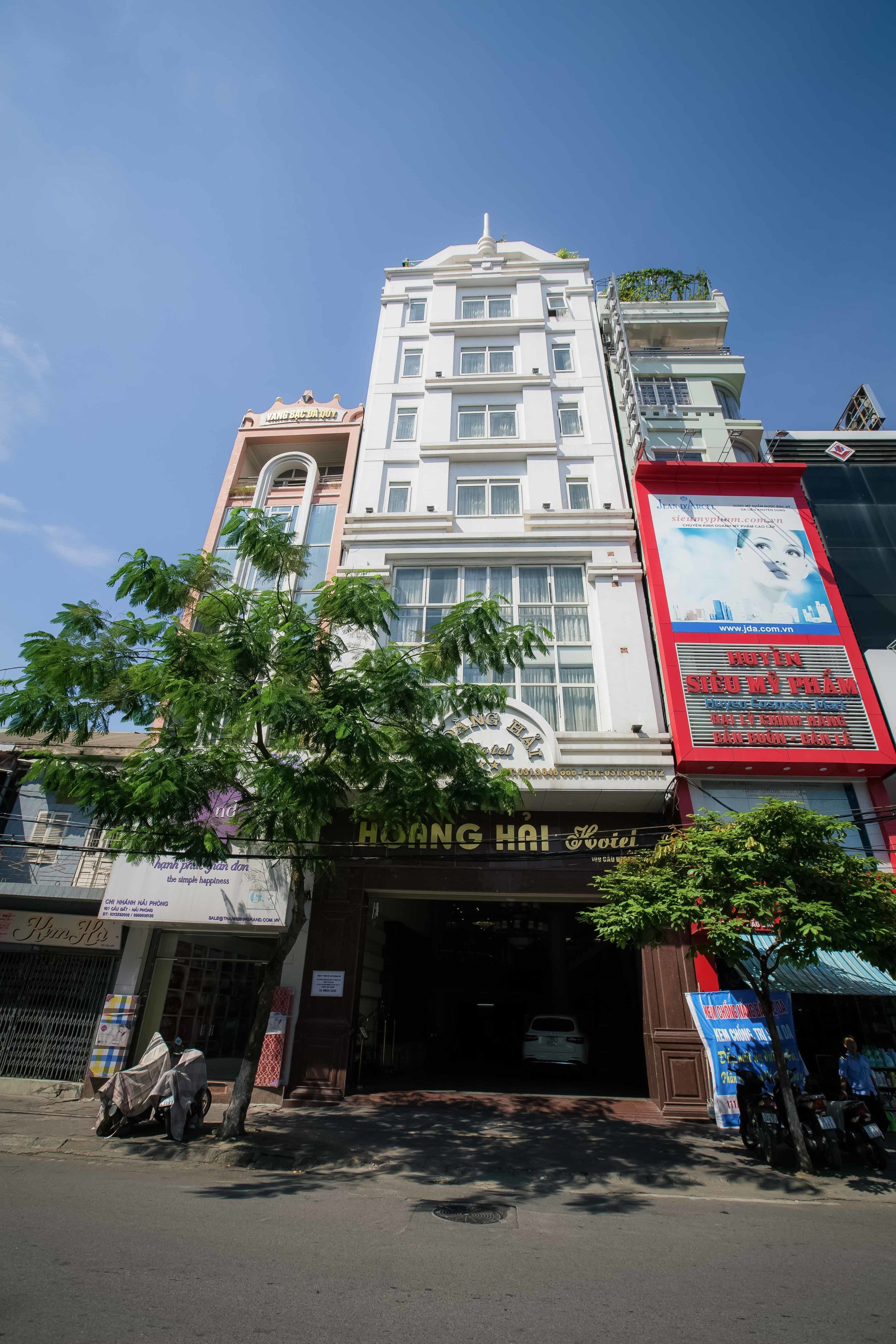 A multi-story building with a sign reading "Hoang Hai".