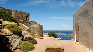 A stone building with a view of the sea. - Aigis Suites (Kea)