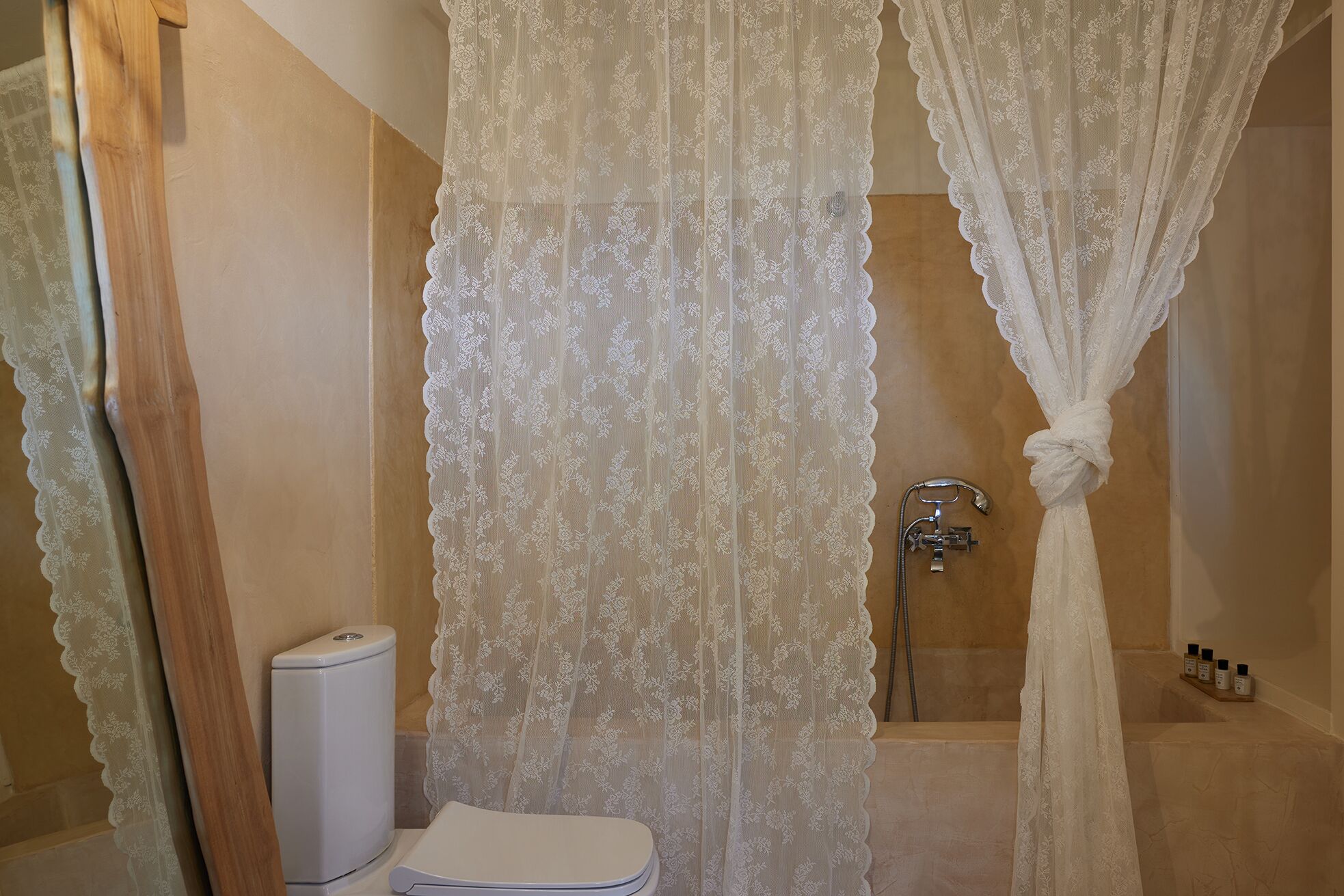 A bathroom with a shower, toilet, and a sink.