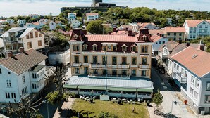 A historic building with a central courtyard, multiple balconies, and a surrounding street.