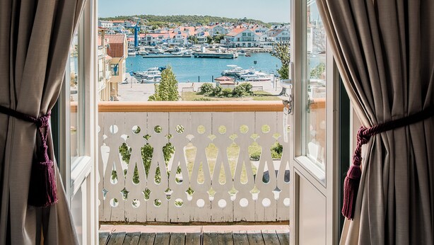 A balcony with a view of a marina and buildings.