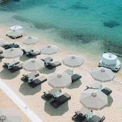 On the beach, white sand, sun-loungers, beach umbrellas