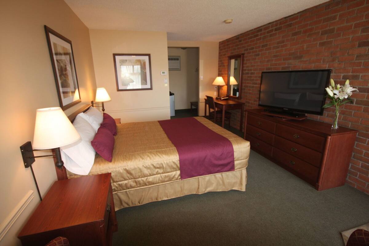 Hypo-allergenic bedding, desk, laptop workspace, blackout drapes