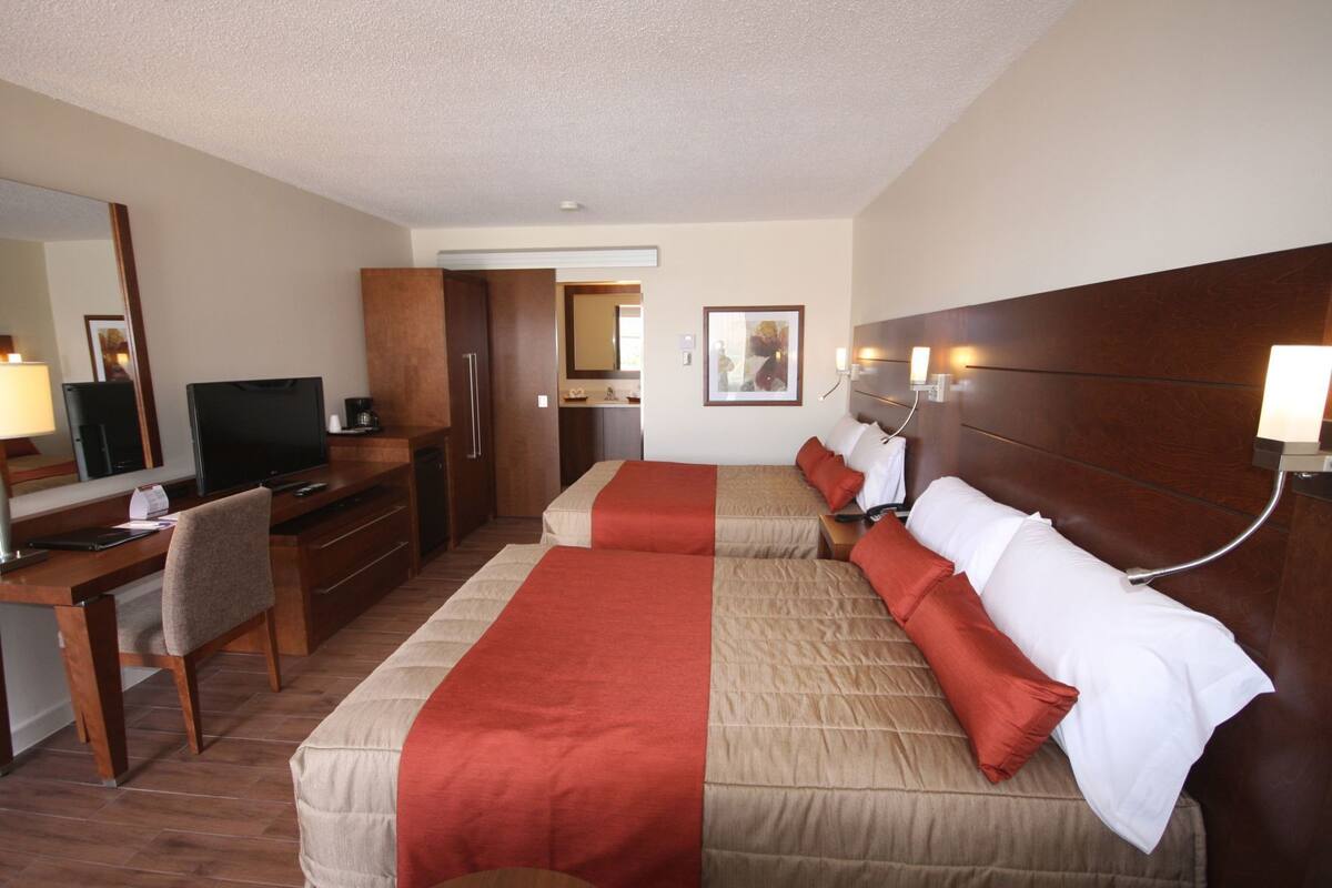 Hypo-allergenic bedding, desk, laptop workspace, blackout drapes