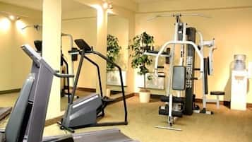 A gym with cardio equipment, weight machines, and a mirror.
