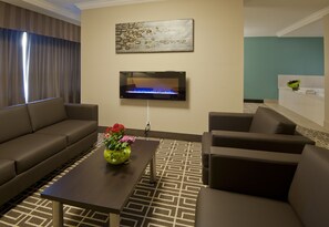 Luxury Suite, 1 King Bed, Jetted Tub | Living room | 50-inch Smart TV with cable channels, TV - Visitors Inn (Hamilton)