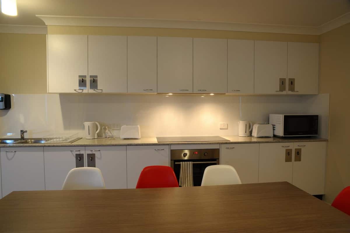 mini-fridge, microwave, electric kettle, cookware/dishes/utensils