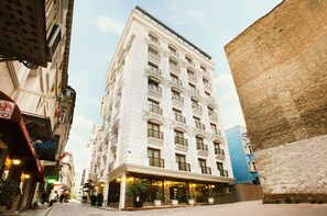 A multi-story hotel with a classic architectural style, featuring balconies and large windows. - Pera Center Hotel (Istanbul)