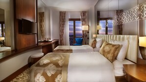 A hotel room with two beds, a TV, a balcony with a view, and a decorative railing. - Pera Center Hotel (Istanbul)