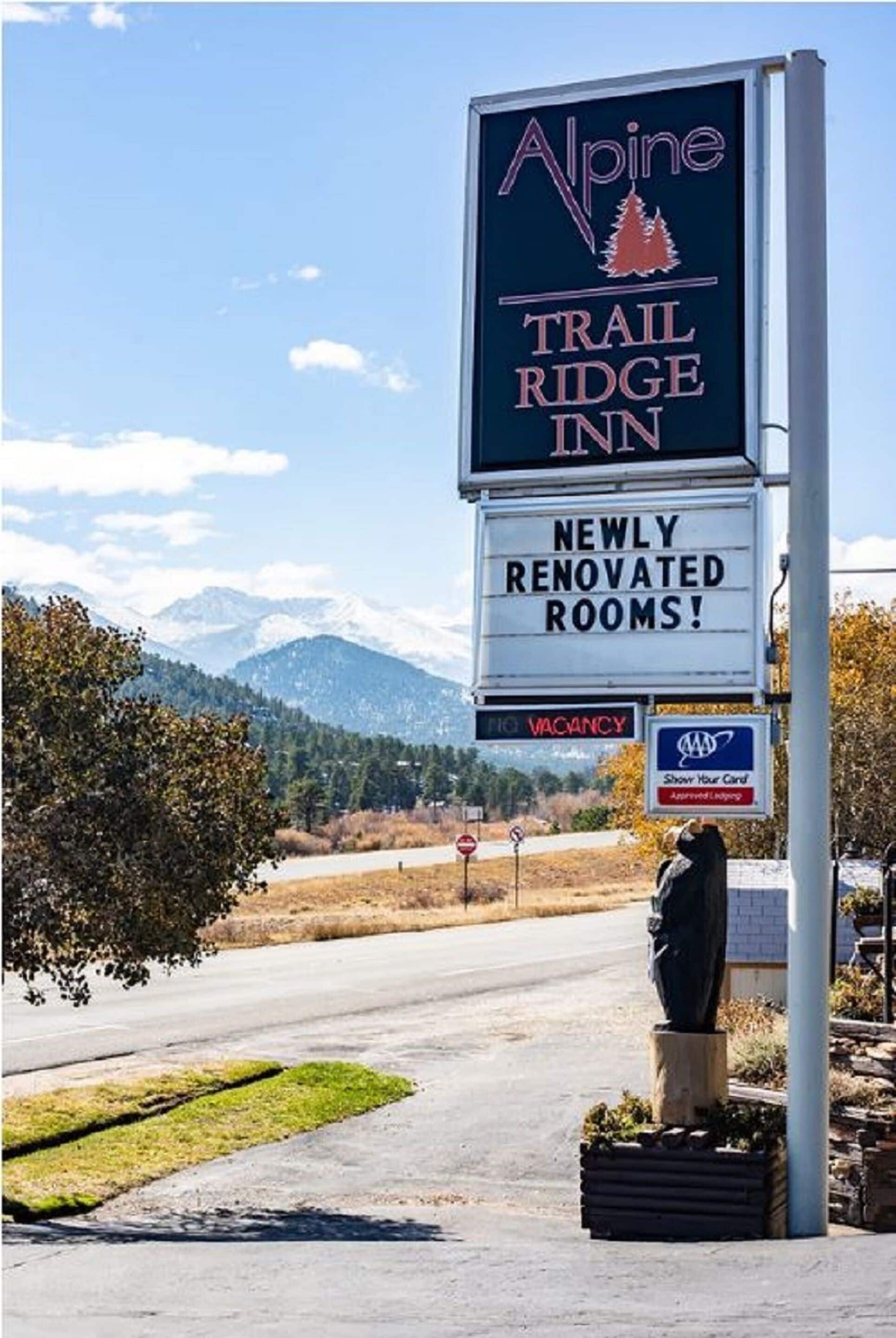 A sign for Alpine Trail Ridge Inn advertising newly renovated rooms.