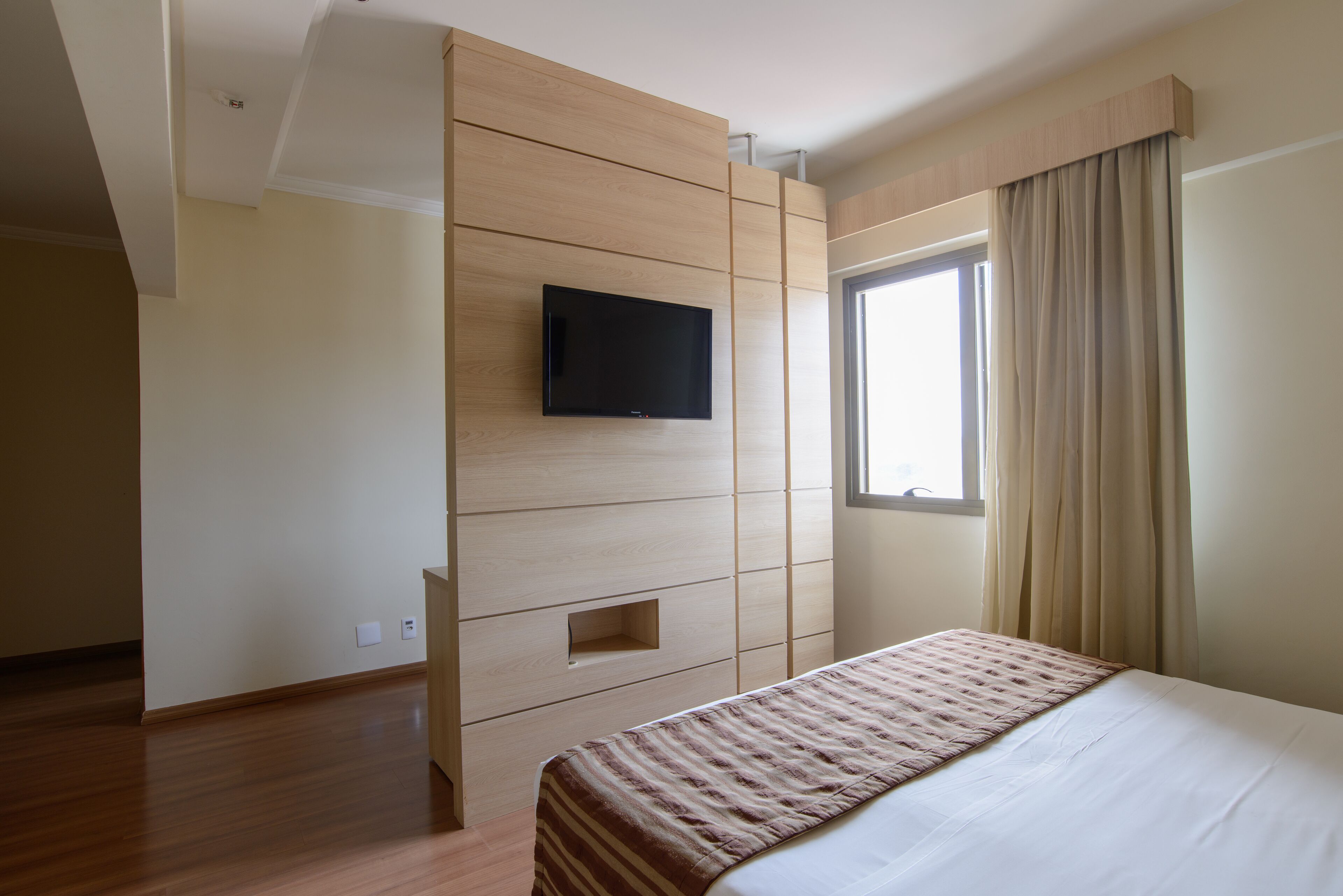 deluxe room | minibar, in-room safe, laptop workspace, blackout curtains