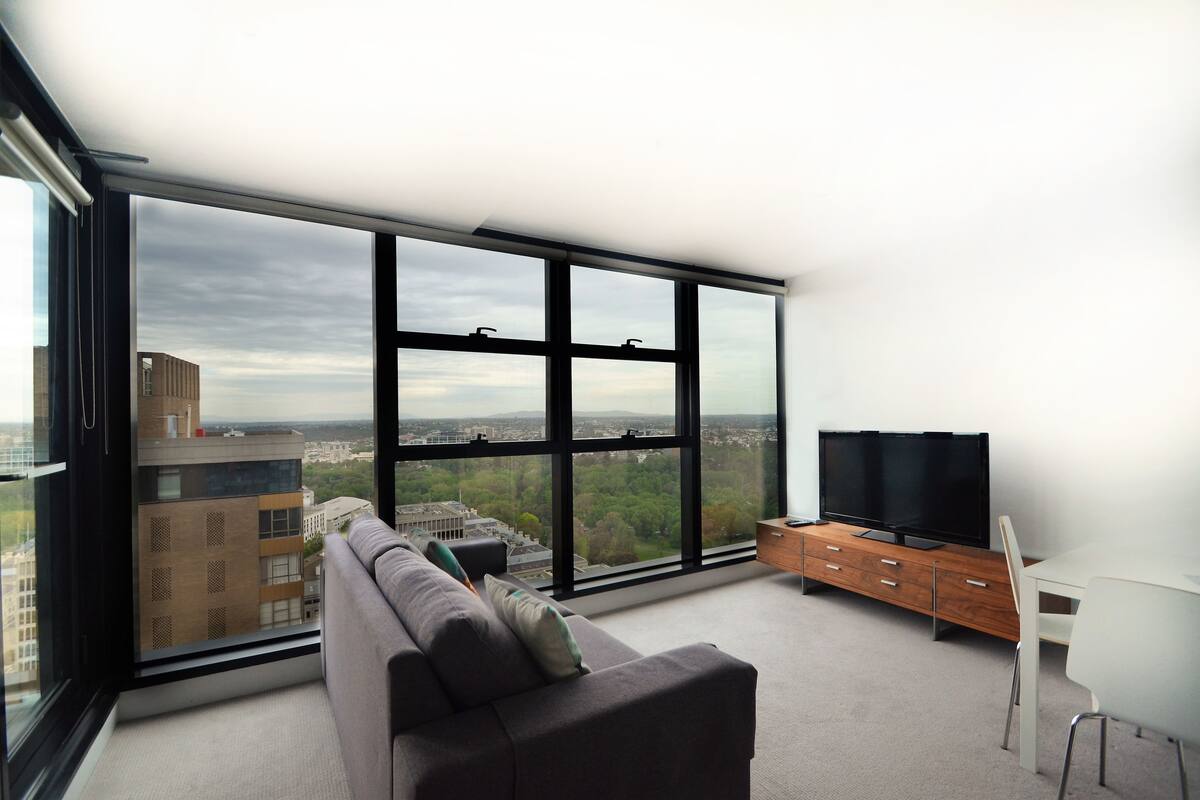 One Bedroom Corner Apartment | Living area | 32-inch LCD TV with cable channels, TV, DVD player