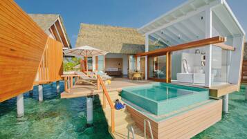 An overwater bungalow with a private pool, wooden deck, and thatched-roof structure.