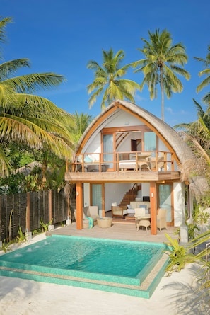 A two-story house with a pool, surrounded by palm trees. - Kandolhu Maldives (NORTH ARI ATOLL)