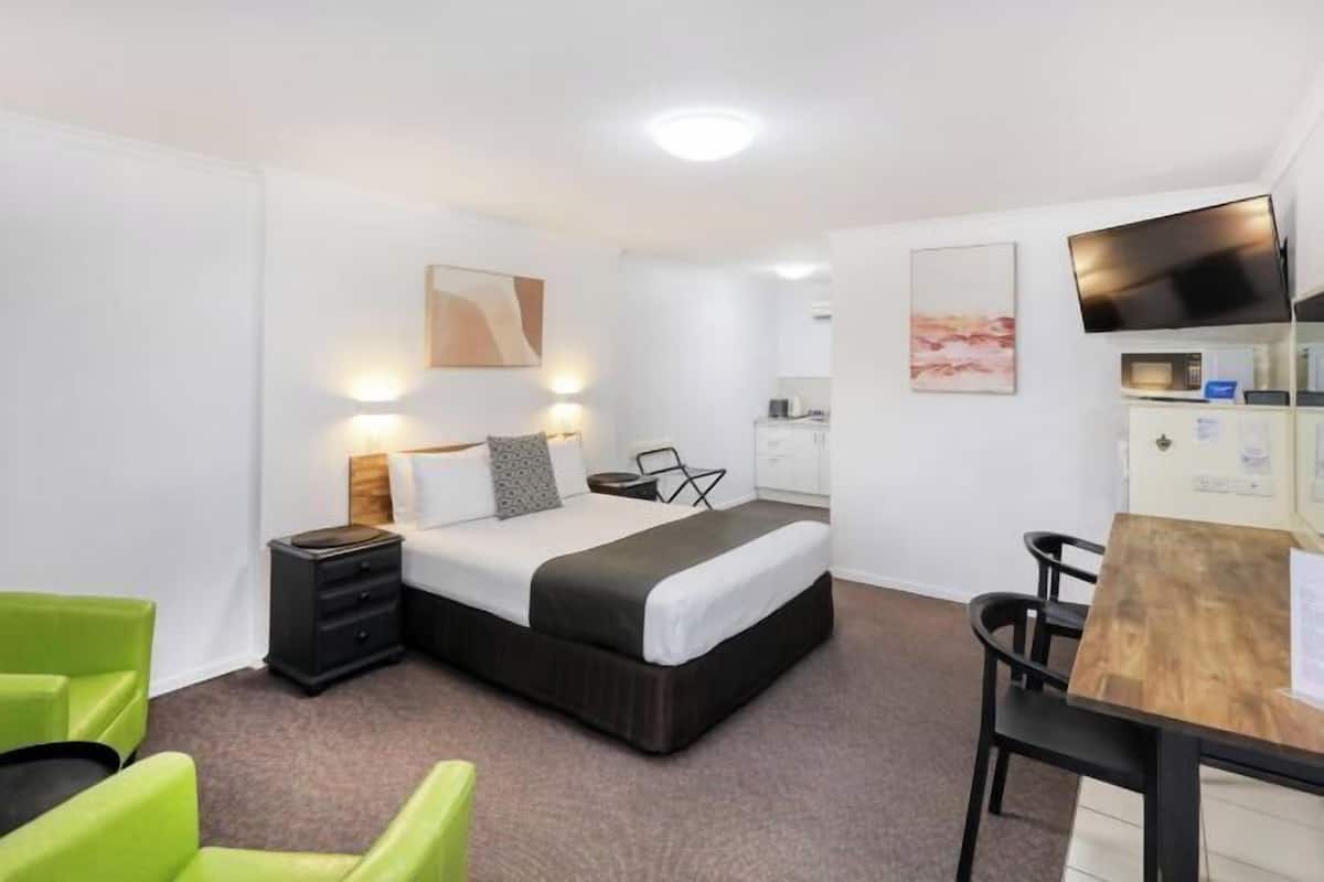 Premium bedding, desk, laptop workspace, blackout drapes