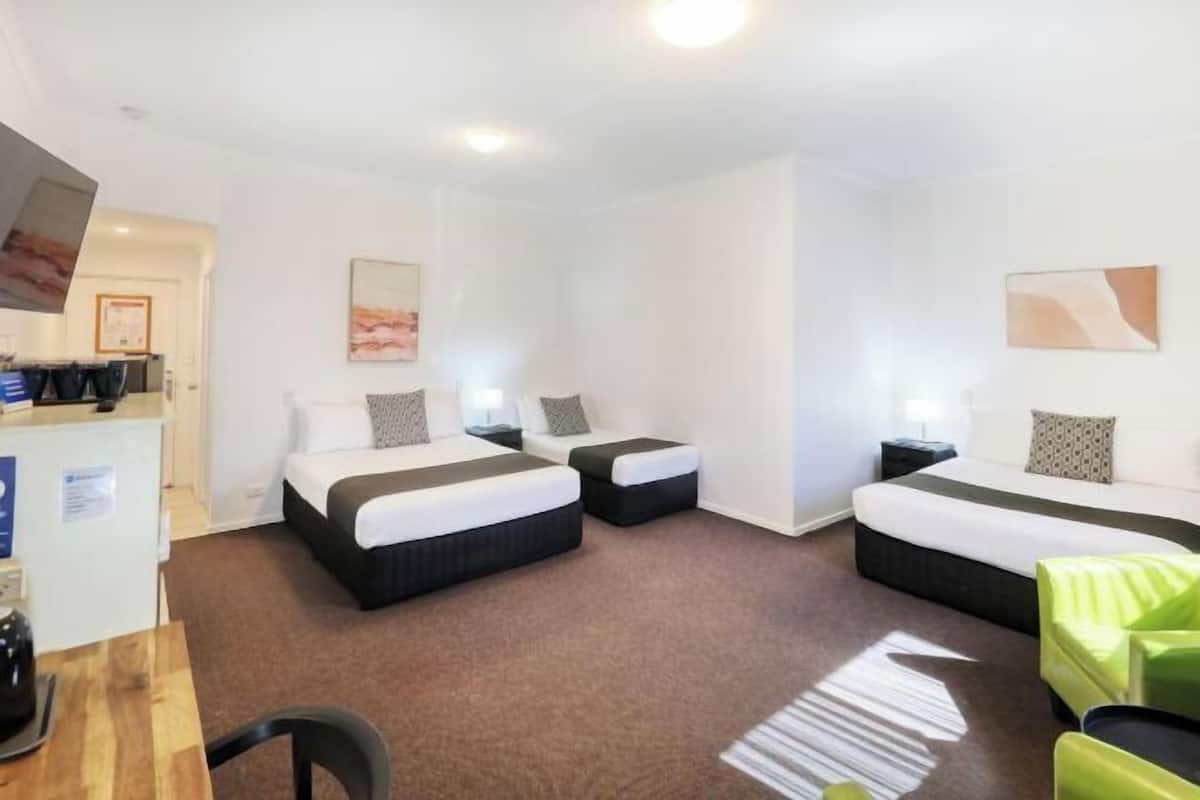 Premium bedding, desk, laptop workspace, blackout drapes