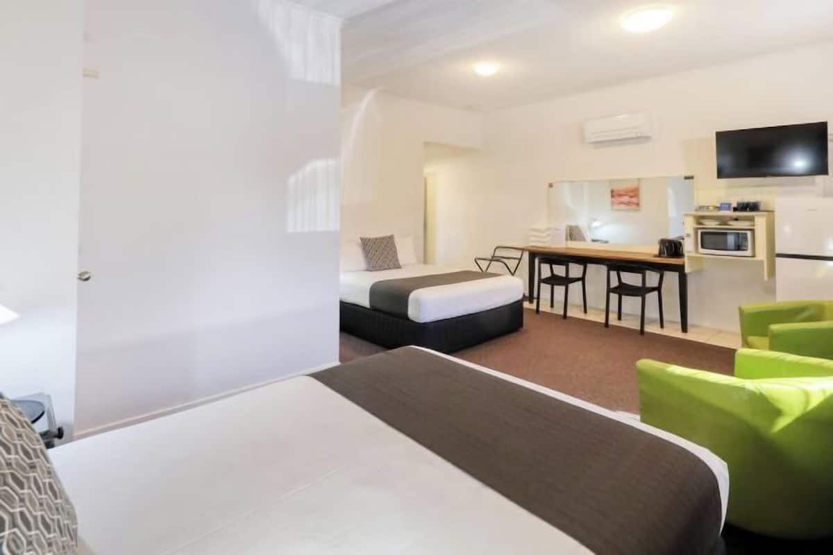 Premium bedding, desk, laptop workspace, blackout drapes