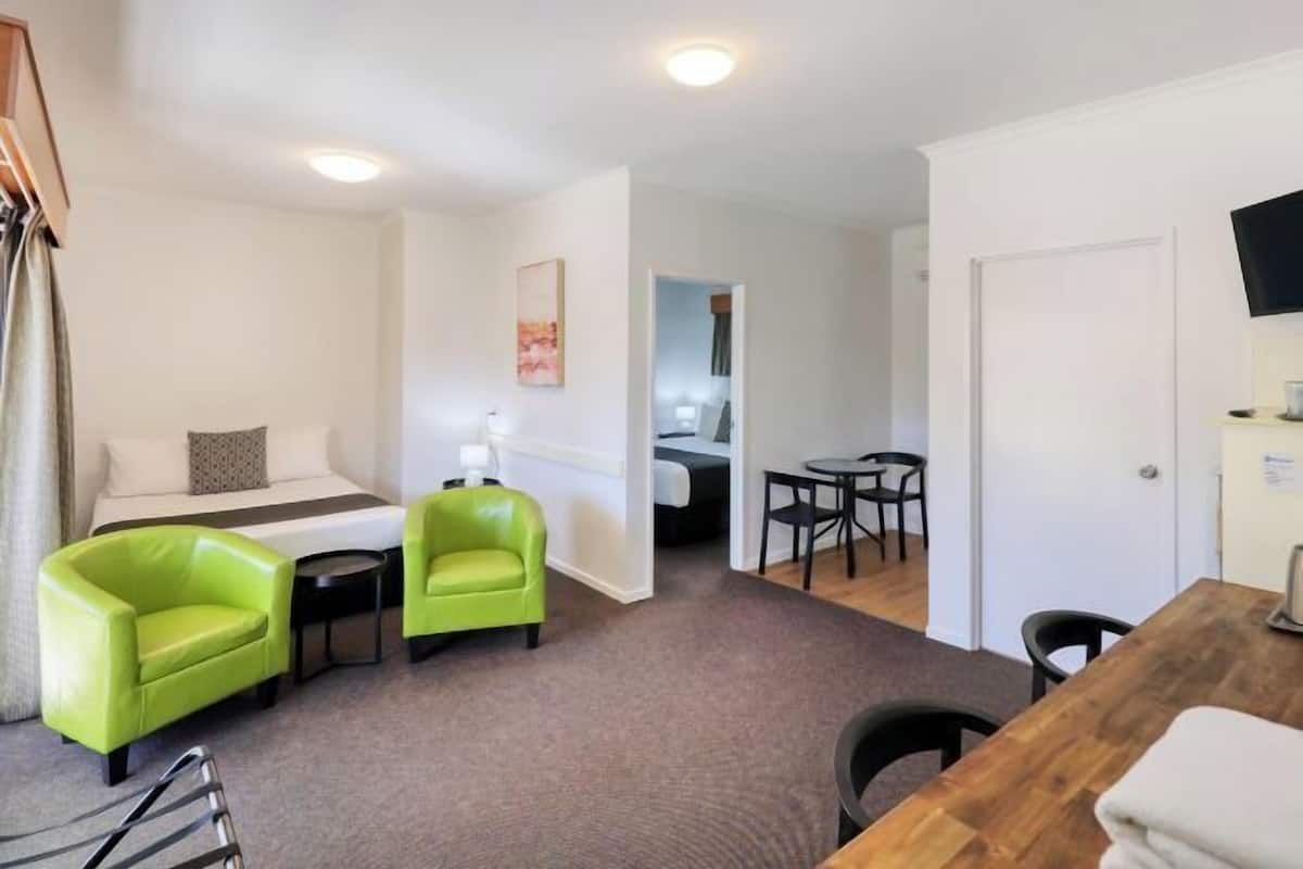 Premium bedding, desk, laptop workspace, blackout drapes