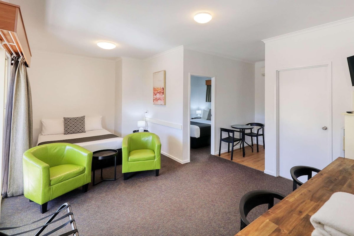Premium bedding, desk, laptop workspace, blackout drapes