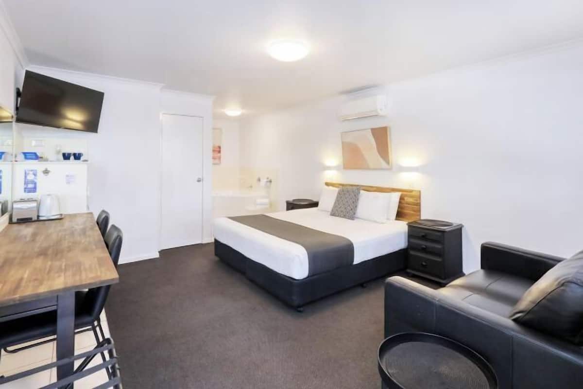 Premium bedding, desk, laptop workspace, blackout drapes