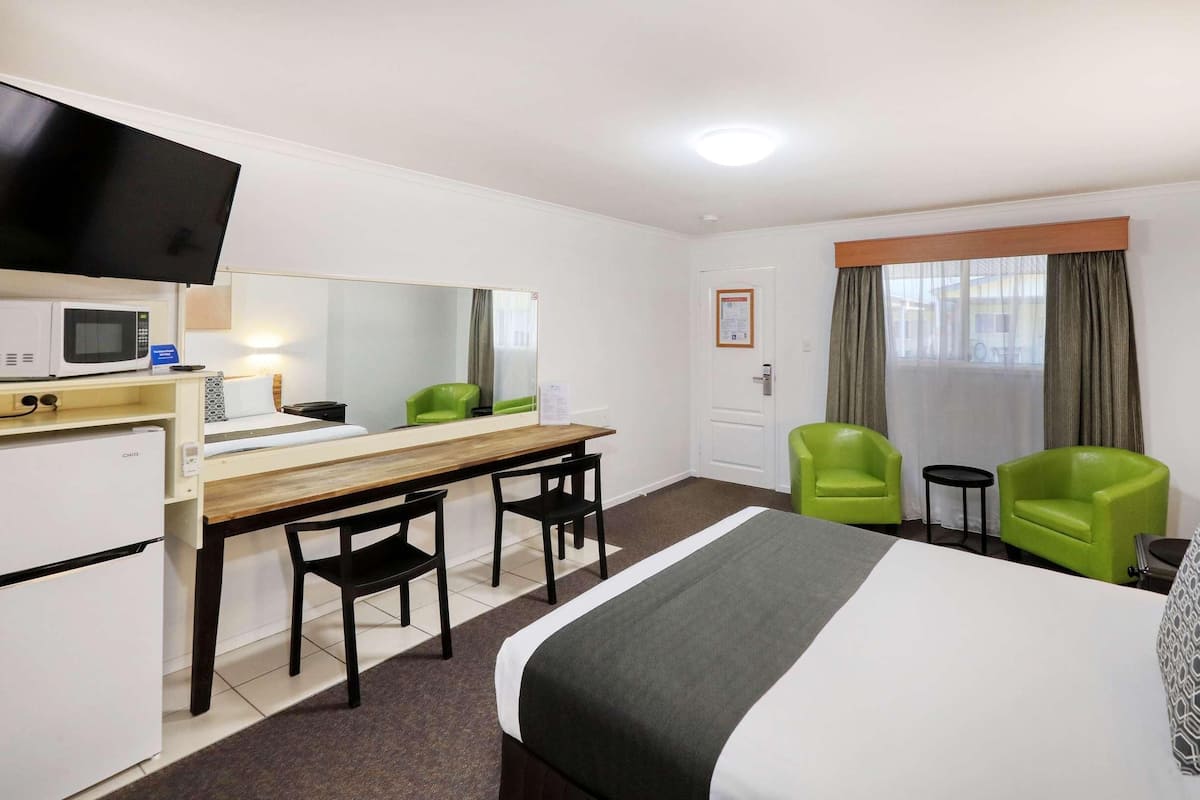 Premium bedding, desk, laptop workspace, blackout drapes