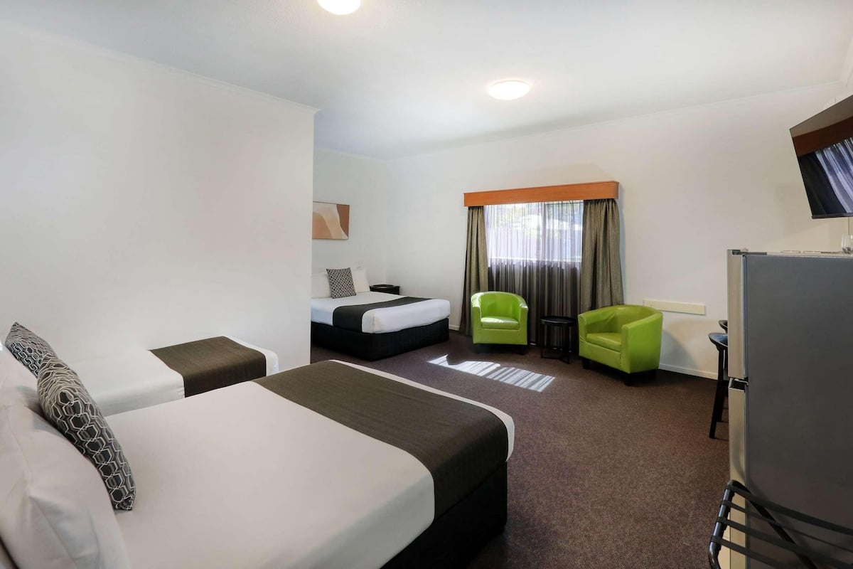 Premium bedding, desk, laptop workspace, blackout drapes