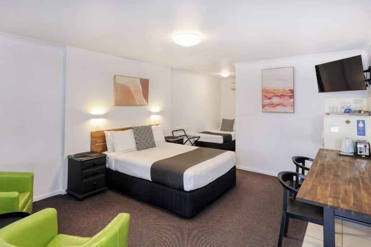 Premium bedding, desk, laptop workspace, blackout drapes