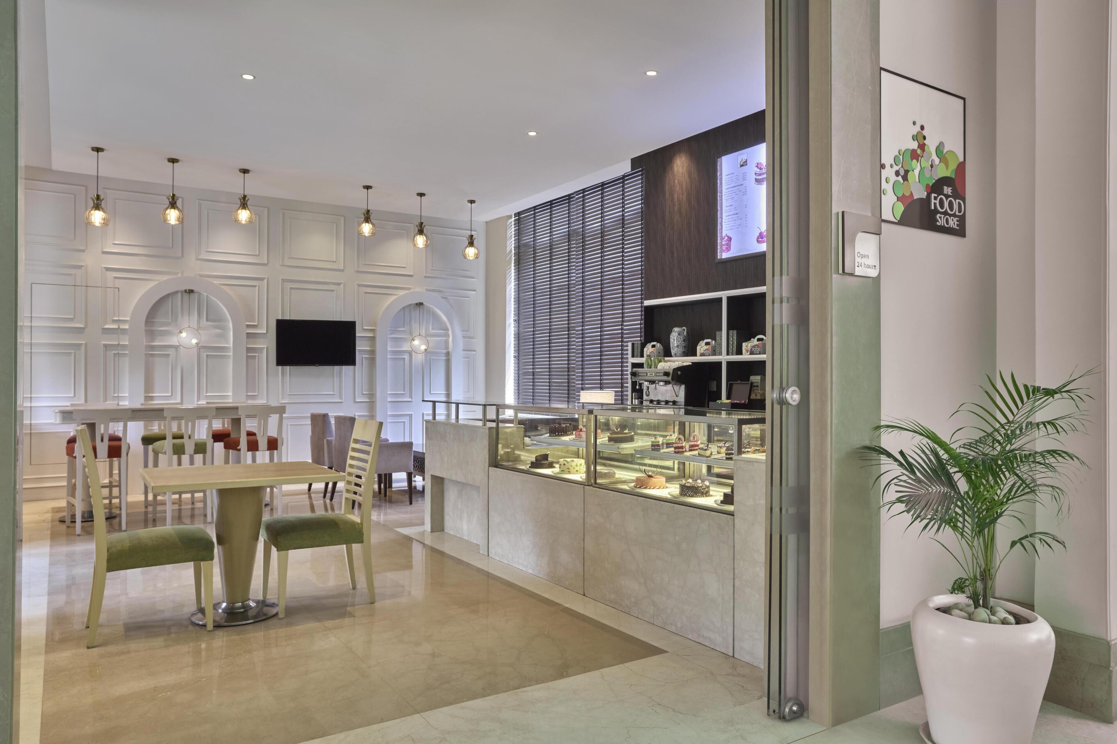 Un interior moderno con una zona de comedor, una vitrina y una planta en maceta.