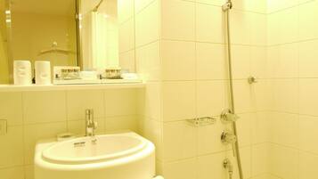A bathroom with a sink, mirror, and shower.