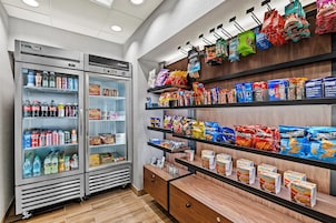 A snack and beverage vending area with various products and a refrigerated section.
