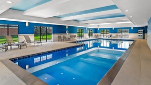 A modern indoor swimming pool with blue tiles, a clear pool, and a sunlit ceiling. - Hampton Inn Omaha/West Dodge Road (Old Mill) (Omaha)