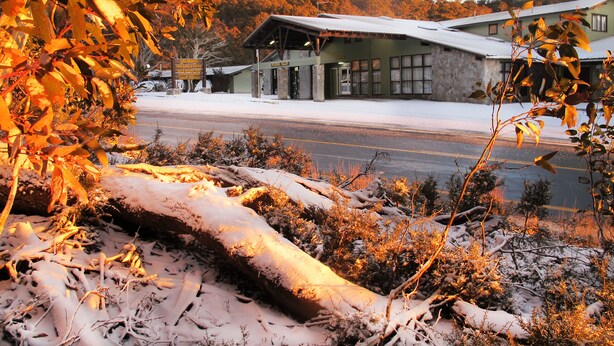 A building with a sign that reads "SOUTHERN CROSS HOTEL" and a covered entrance. - Ski Rider Hotel (Wilsons Valley)
