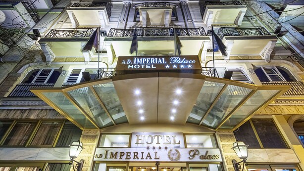 The exterior of A.D. Imperial Palace Hotel with a prominent sign, large windows, and ornate balconies. - Imperial Palace Classical Hotel Thessaloniki (Thessaloniki)
