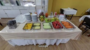 A buffet table with various food items and drinks, covered with a white tablecloth. - Hara Palace Hotel (Curitiba)