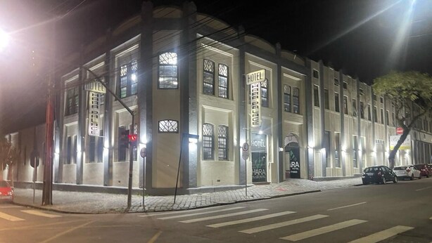 A hotel with a classic architectural style, featuring large windows and a prominent entrance. - Hara Palace Hotel (Curitiba)
