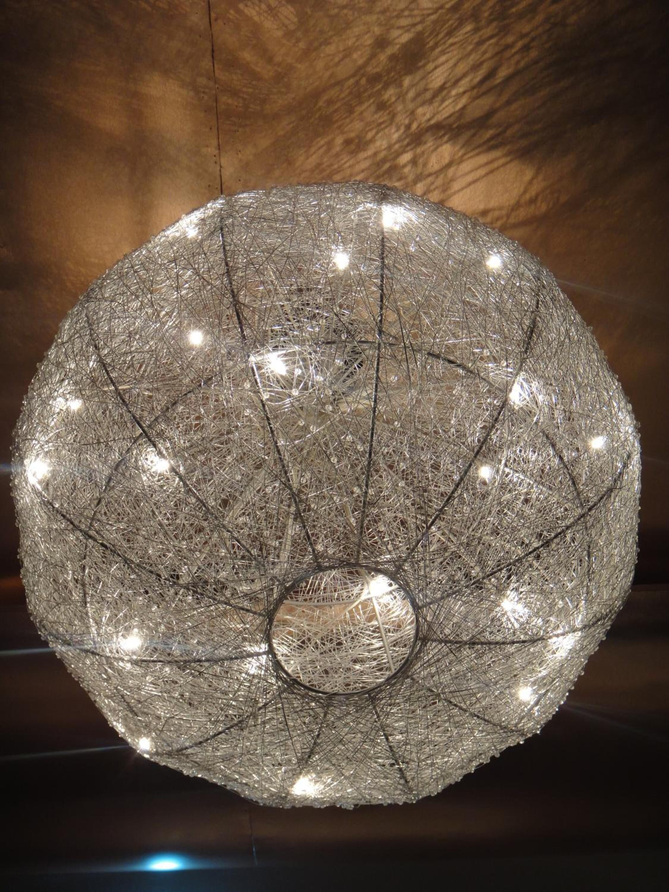 A spherical chandelier with multiple light bulbs.