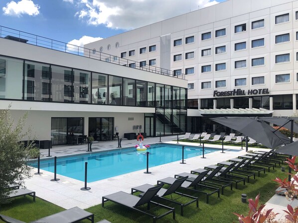 Seasonal outdoor pool, open 9:00 AM to 9:00 PM, pool umbrellas