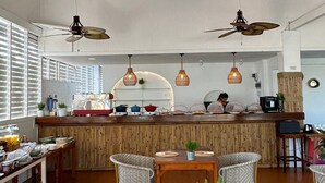 A restaurant with bamboo ceiling panels, hanging wicker pendant lights, and wicker chairs. - Treeya Lanta (Ko Lanta)