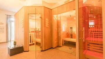 A modern spa room with wooden paneling, glass doors, and a bench.
