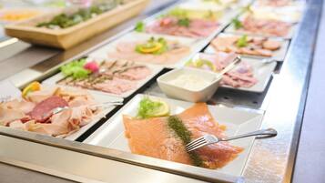 A buffet with various food items including salmon, meats, and salads.